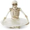 K&K Interiors 10-Inch Resin Sitting Skeleton Holding Glass Plate Decoration 1 K&K Interiors 10-Inch Resin Sitting Skeleton Holding Glass Plate Decoration -Skeletons And Skulls Sales Shop 10 resin sitting skeleton holding glass plate